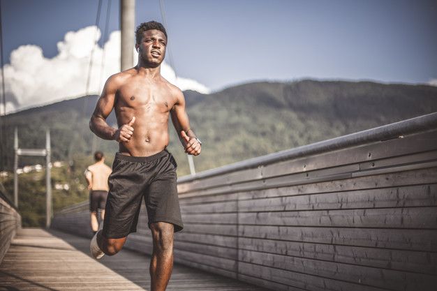 young athletic black man jogs wooden bridge outside city - Bạn Có Bị Đỏ Mặt Khi Chạy Bộ? Nó Có Gây Nguy Hiểm?