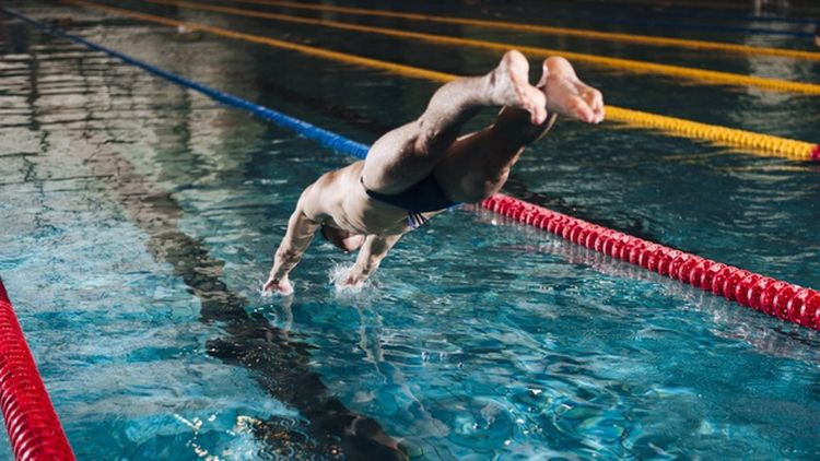 high-angle-male-swimmer-diving-basin
